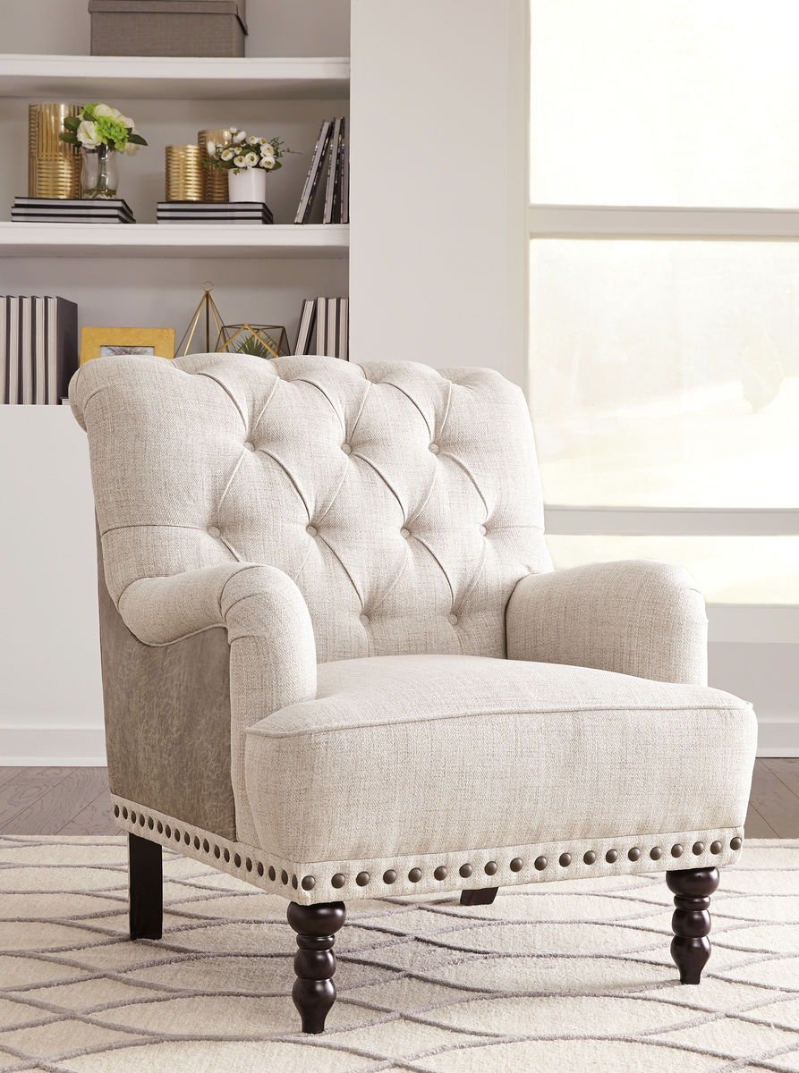 A minimalist accent chair beside a side table in a quiet room.
