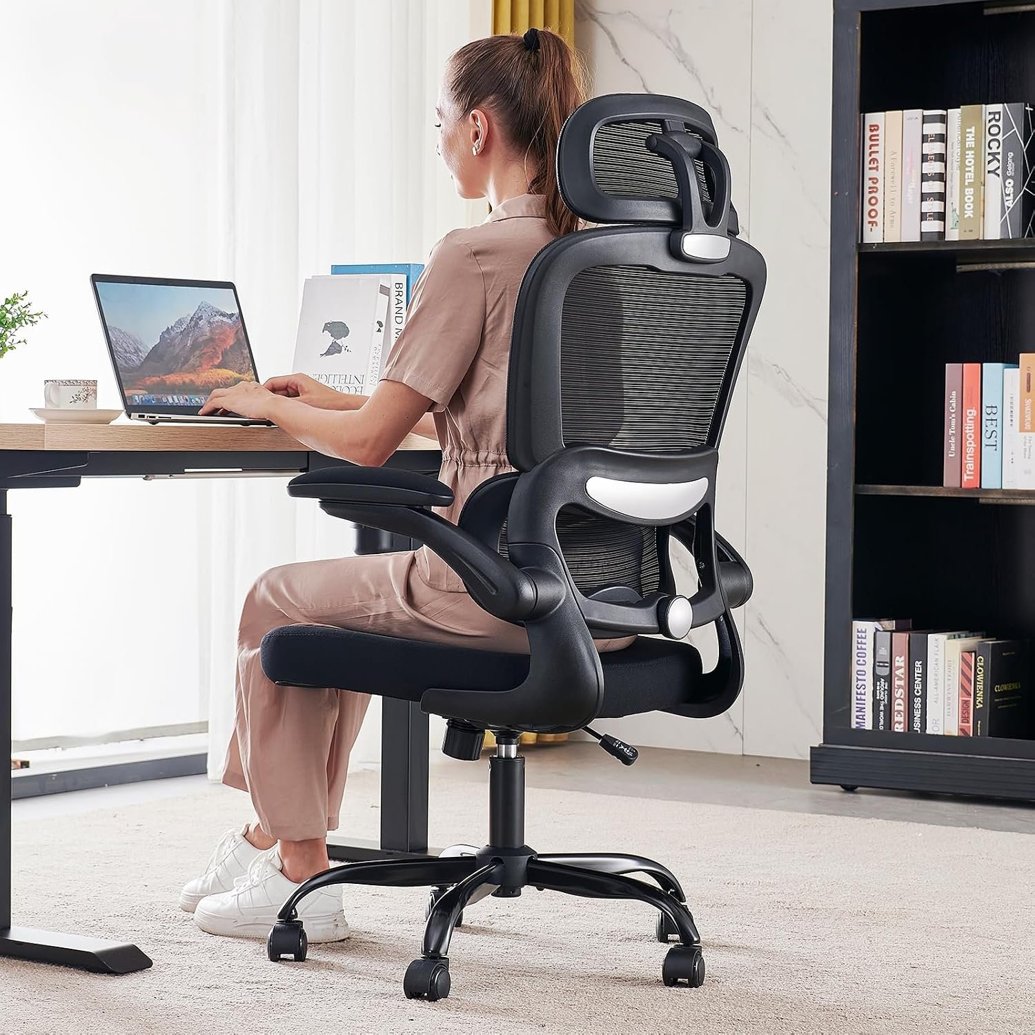 Adjusting the lumbar support on a high-quality ergonomic chair for better back health.