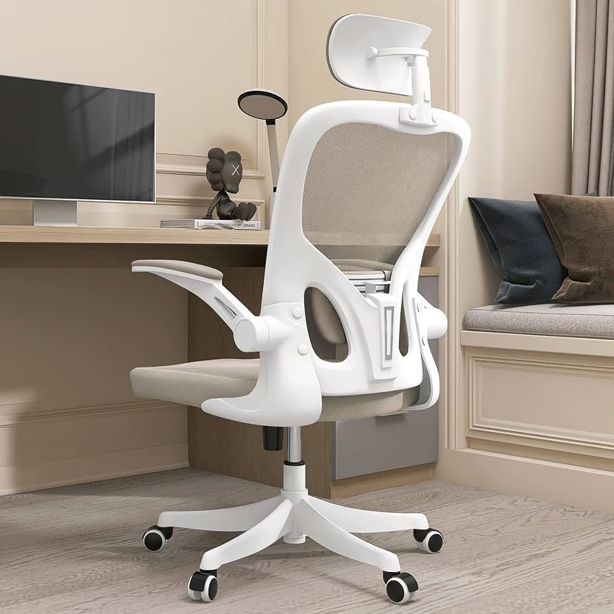 A person sitting with excellent posture in an ergonomic chair to prevent musculoskeletal strain.