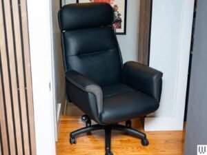 An ergonomic office chair stands in a bright, modern home office workspace.