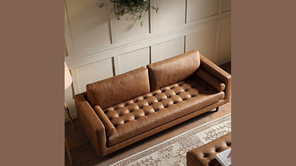 A modern three-person couch placed in a bright living room for scale.