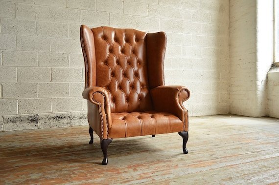 A modern armchair serves as the centerpiece in a bright, professionally styled living room.
