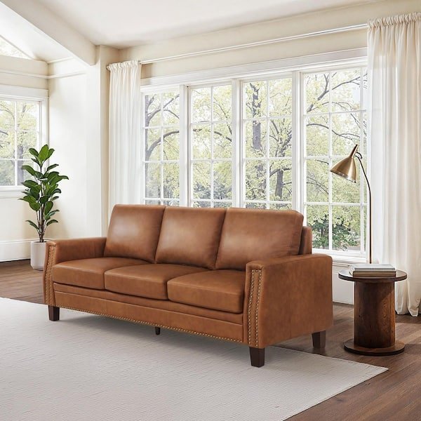 Planning the placement of a three-seater sofa in an empty living room.