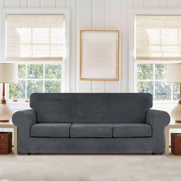 Using a tape measure and painter's tape to accurately determine the sofa length.