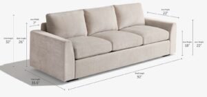 A modern three-cushion sofa positioned perfectly within a bright and spacious living room.