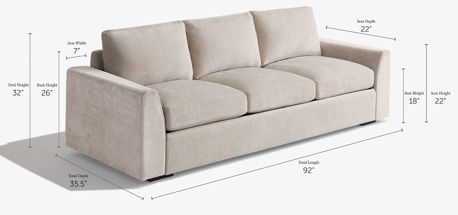 A modern three-cushion sofa positioned perfectly within a bright and spacious living room.