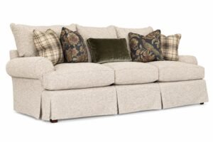 A modern three-cushion couch centerpiece in a bright and spacious contemporary living room.