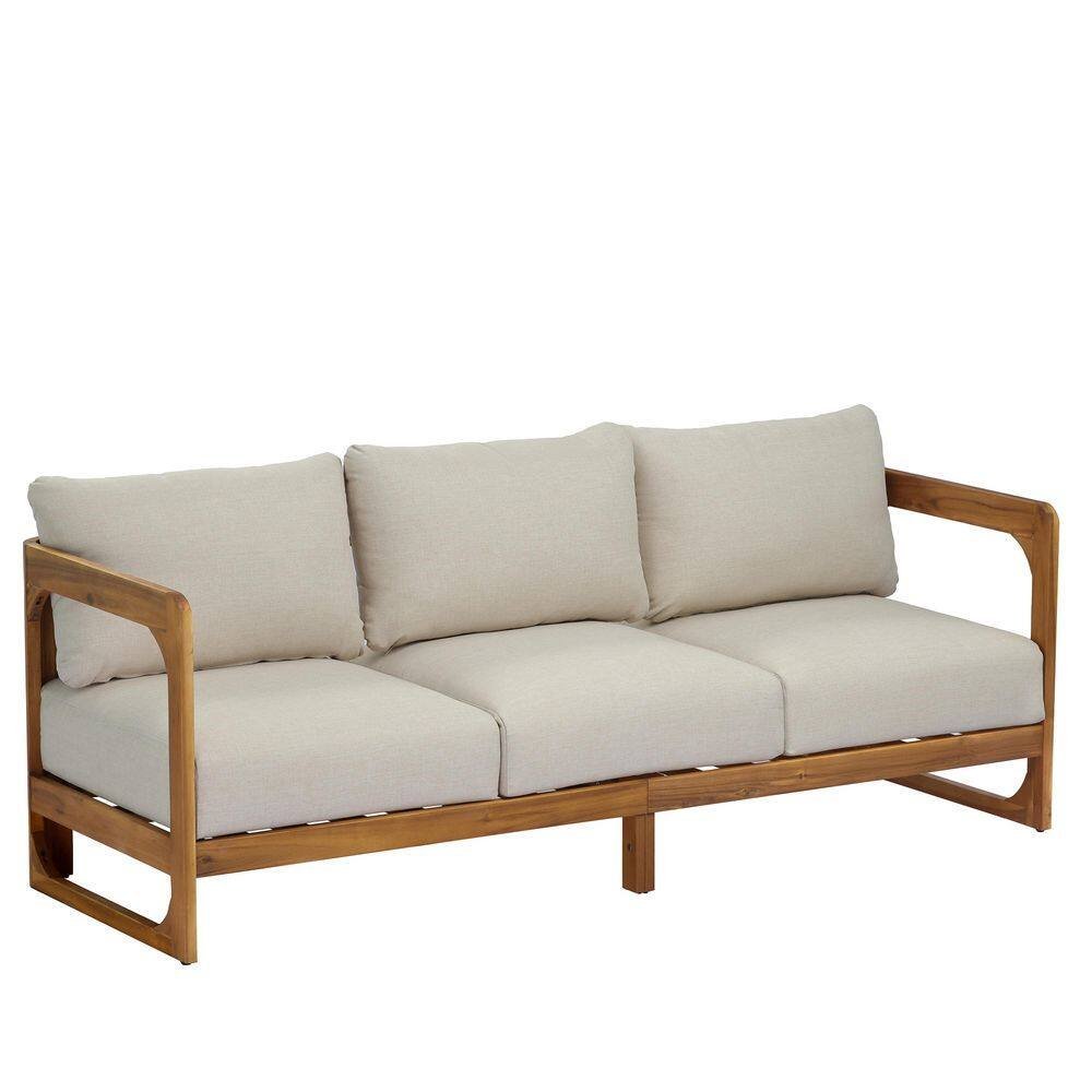 Measuring the total length of a three-seater couch with a metal tape measure.