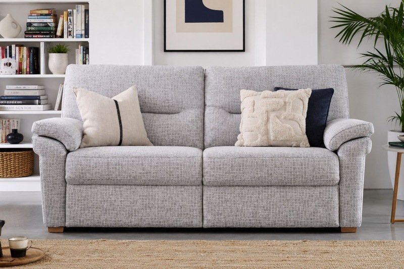 A modern 3 seater sofa sits elegantly in a bright, contemporary living room.