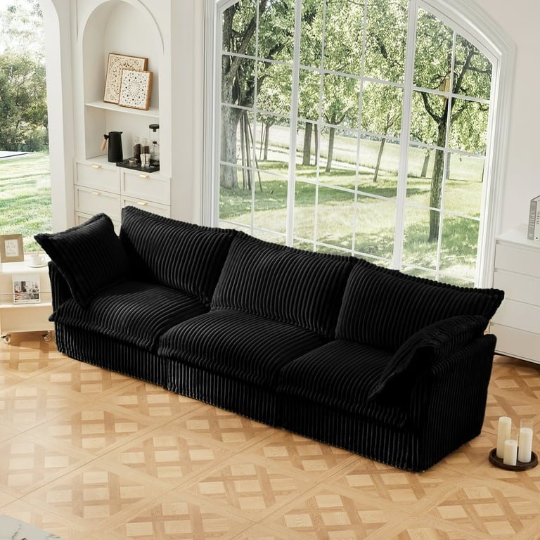 A measuring tape measures the width of a three-seater sofa.