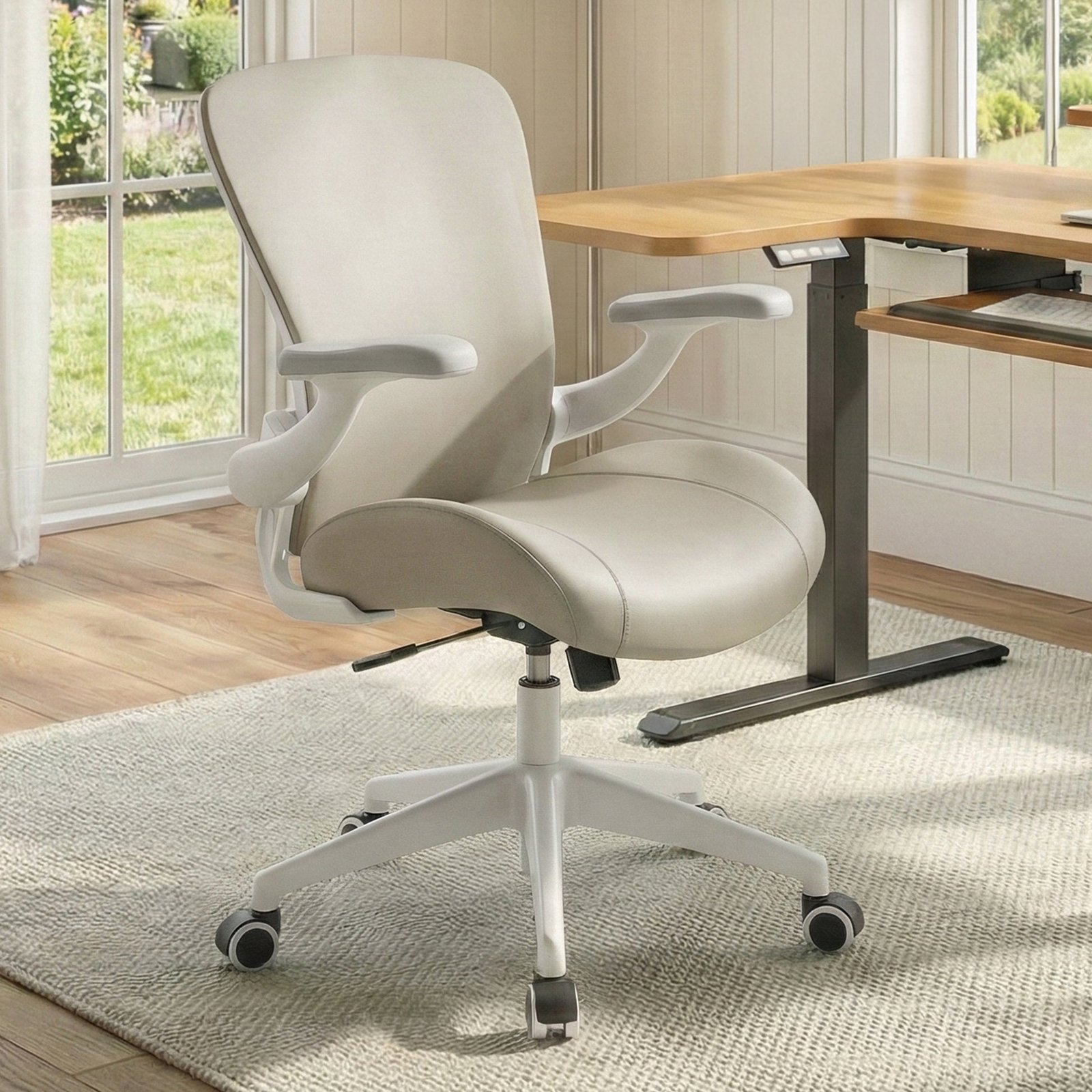 A row of various ergonomic office chairs lined up against a wall.