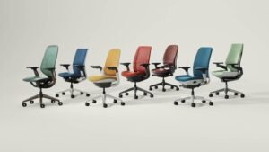 A modern office space filled with rows of ergonomic office chairs.
