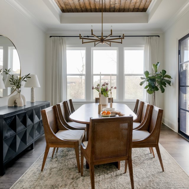 Two different styles of dining chairs placed together in a bright modern room.