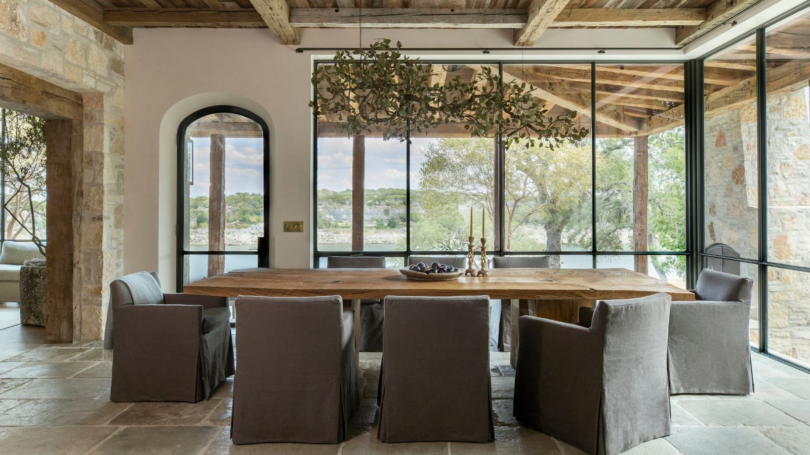 Modern dining room chairs arranged around a wooden table in a well-lit home.
