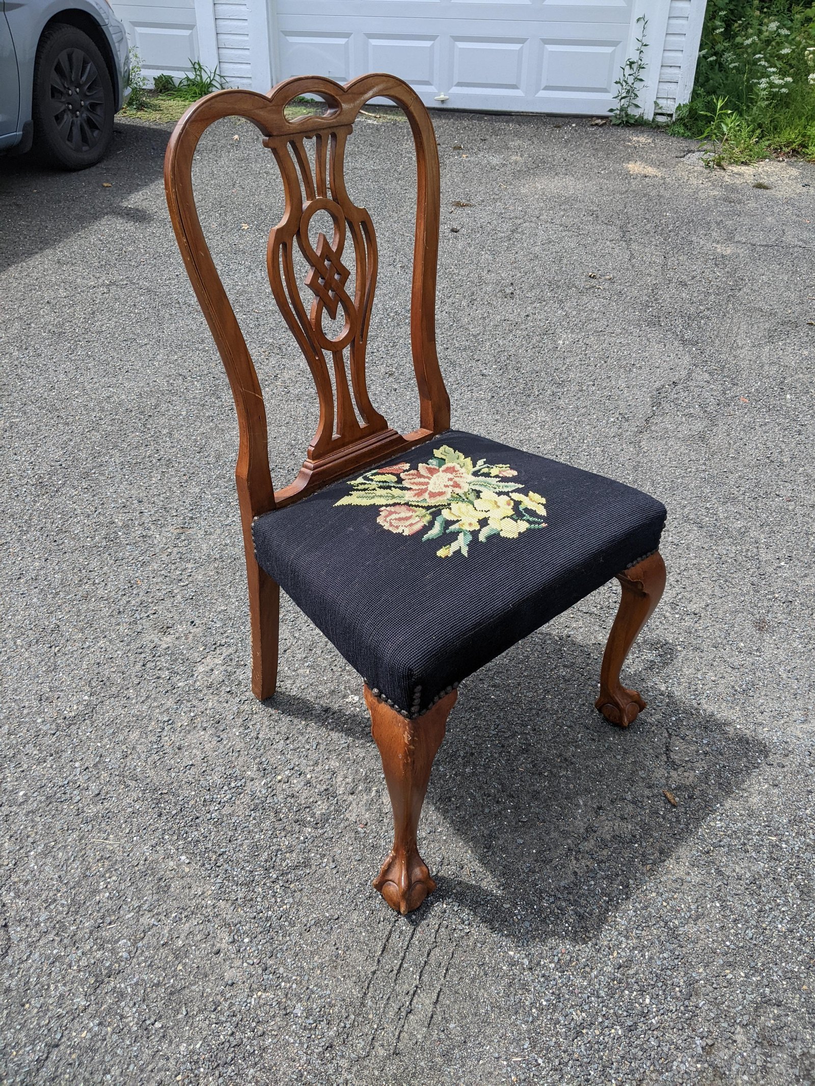 A tablet showing frequently asked questions about dining chairs resting on a modern table.