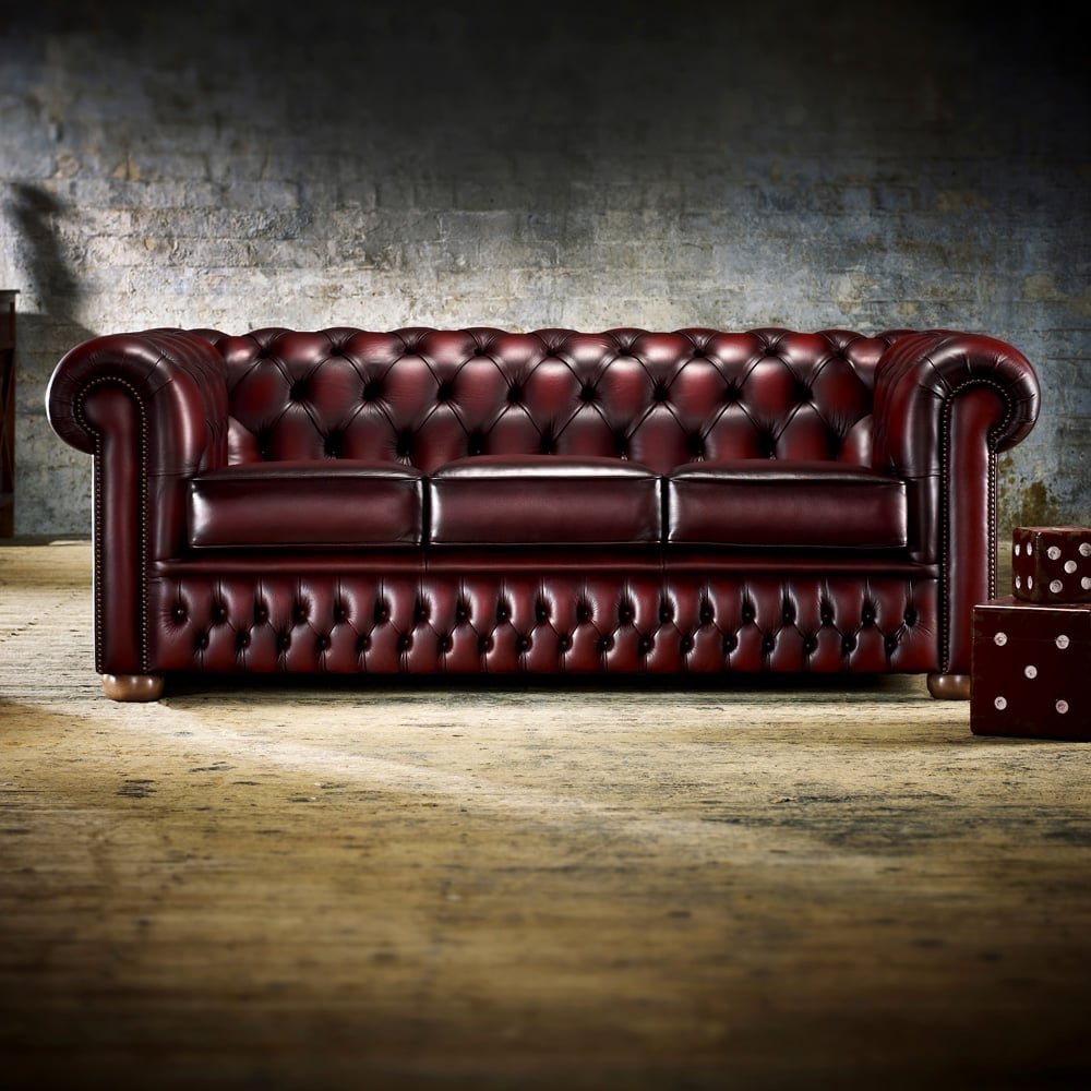A person measures a doorway to ensure a three-seater sofa will fit properly inside.