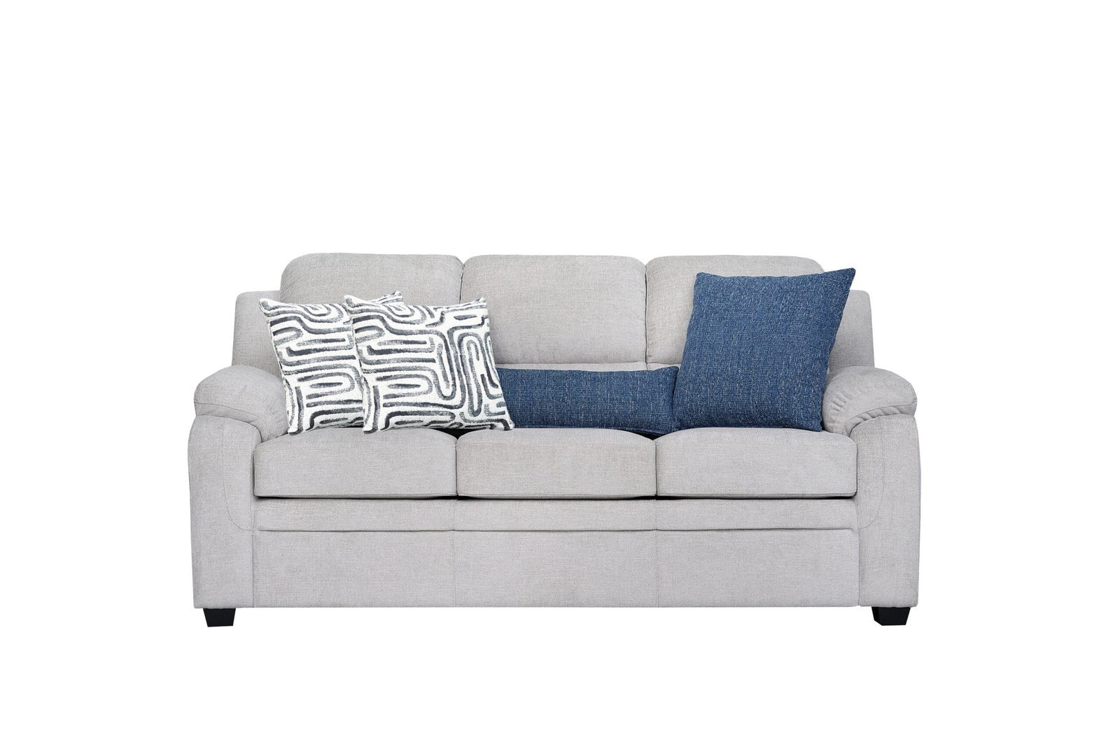 A modern three-seater sofa sits in a bright living room as a central furniture piece.