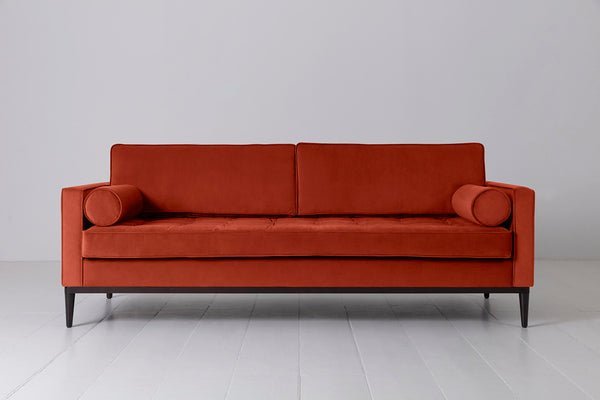 Selecting fabric swatches for a custom sofa in a furniture showroom.
