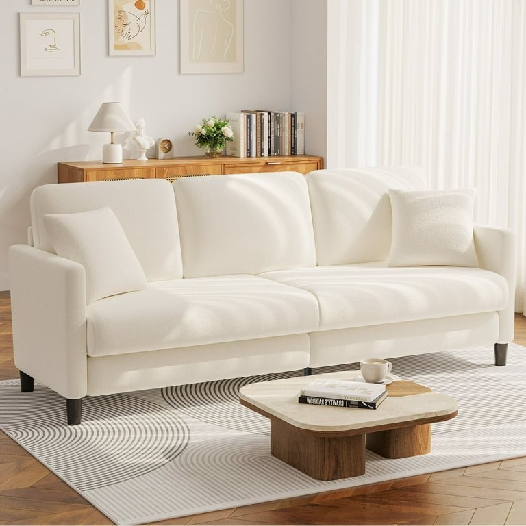 A person measuring a narrow hallway before purchasing a new sofa.