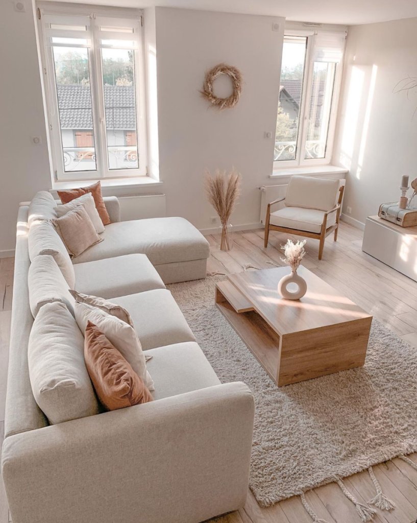 Two accent chairs of varying heights placed in a modern, well-lit living space.