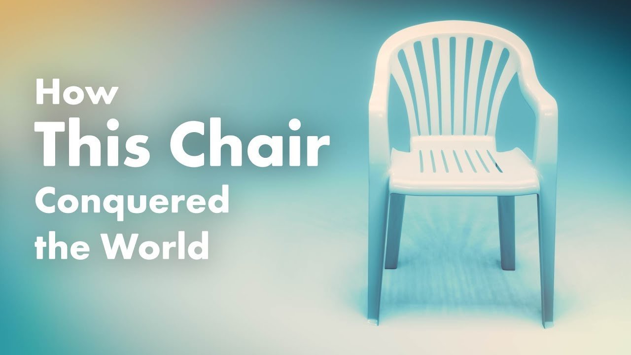 A modern designer chair stands elegantly in a bright, minimalist living room space.