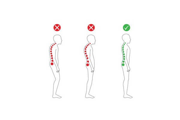 A person checking their alignment to prevent tech neck while working at a computer.
