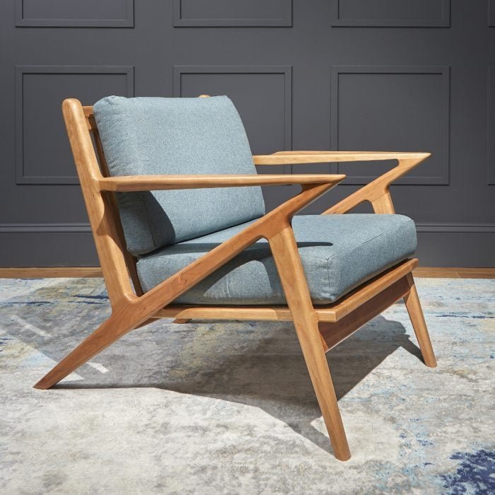 A completed accent chair sits in a quiet, modern living room corner.
