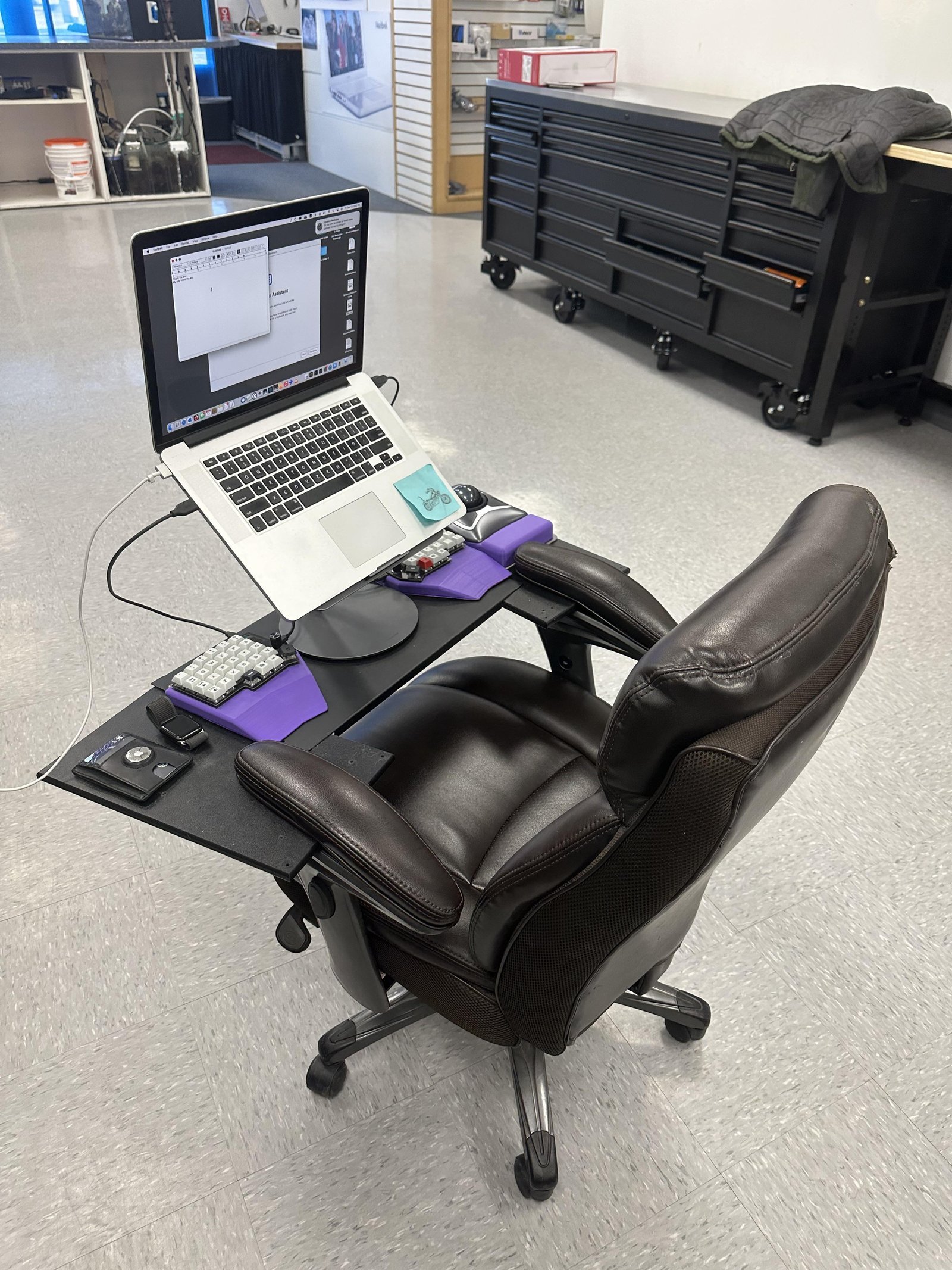 A tidy home office setup with an ergonomic chair, referencing frequently asked questions about assembly.