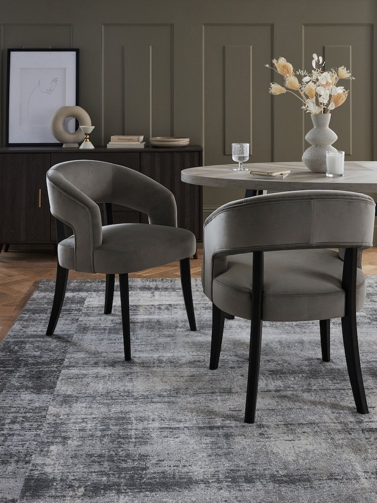 A comfortable dining chair in a bright, modern room during a question session.