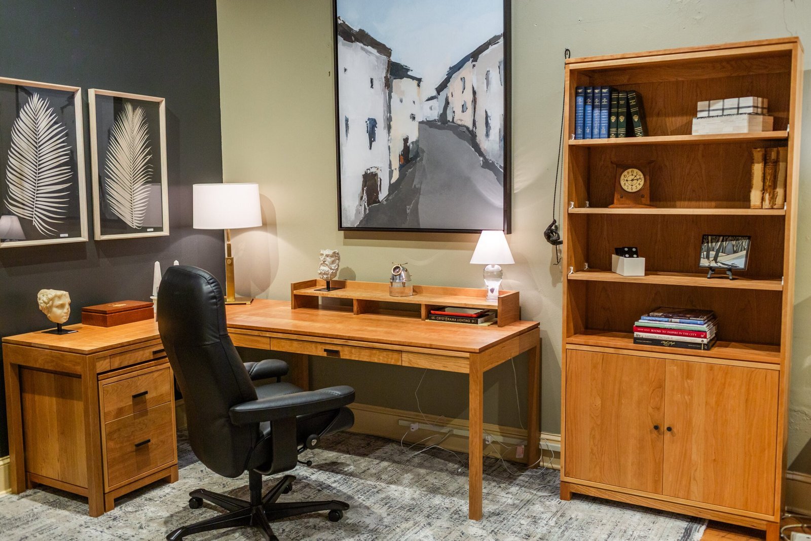 A designer measures space to ensure their new desk matches the room decor.
