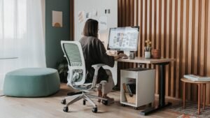 A beautifully decorated desk chair sits in a bright and modern home office.