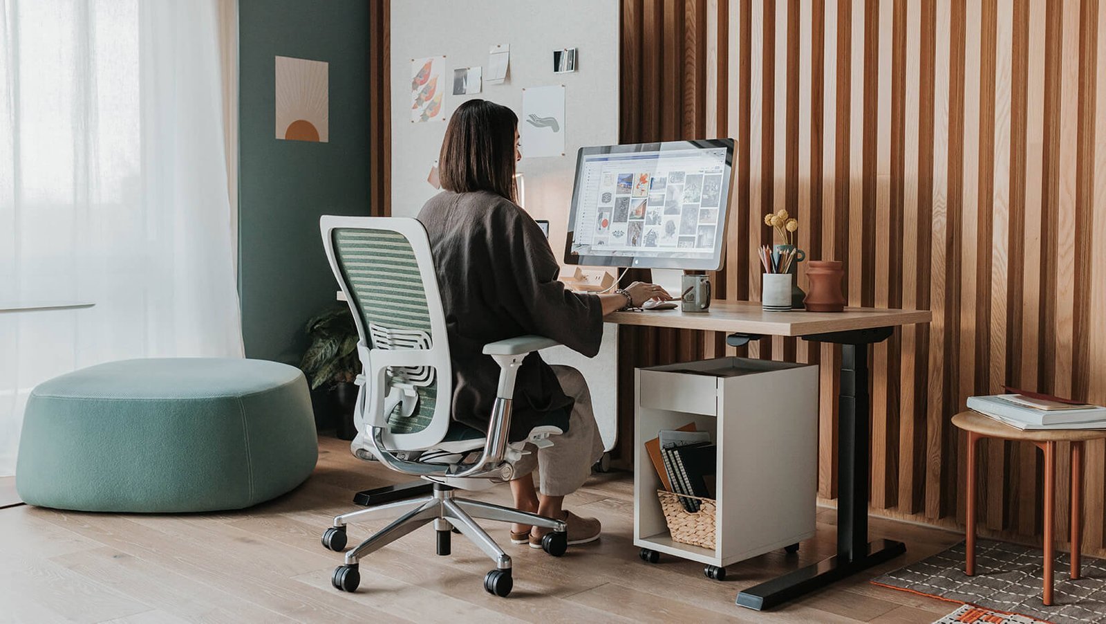 A beautifully decorated desk chair sits in a bright and modern home office.