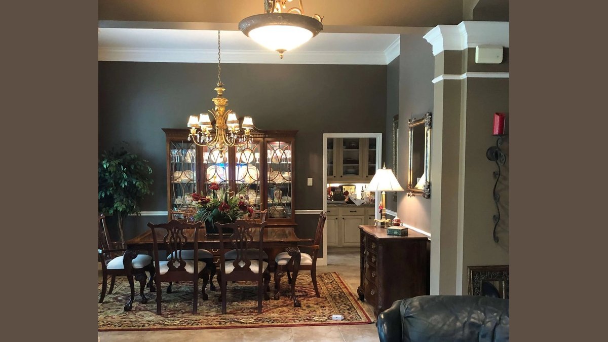 A modern dining room set with decorated chairs and soft linen cushions.
