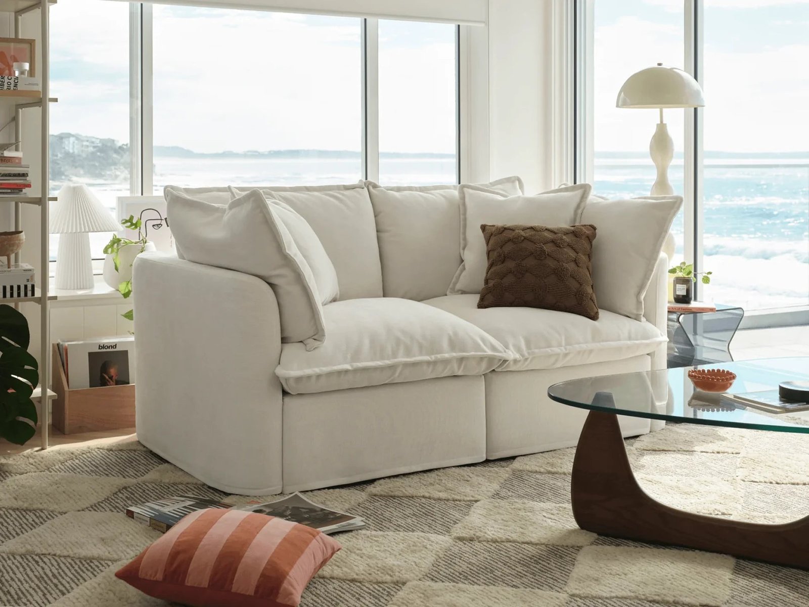 Measuring a sofa to provide accurate dimensions for a furniture sales listing.