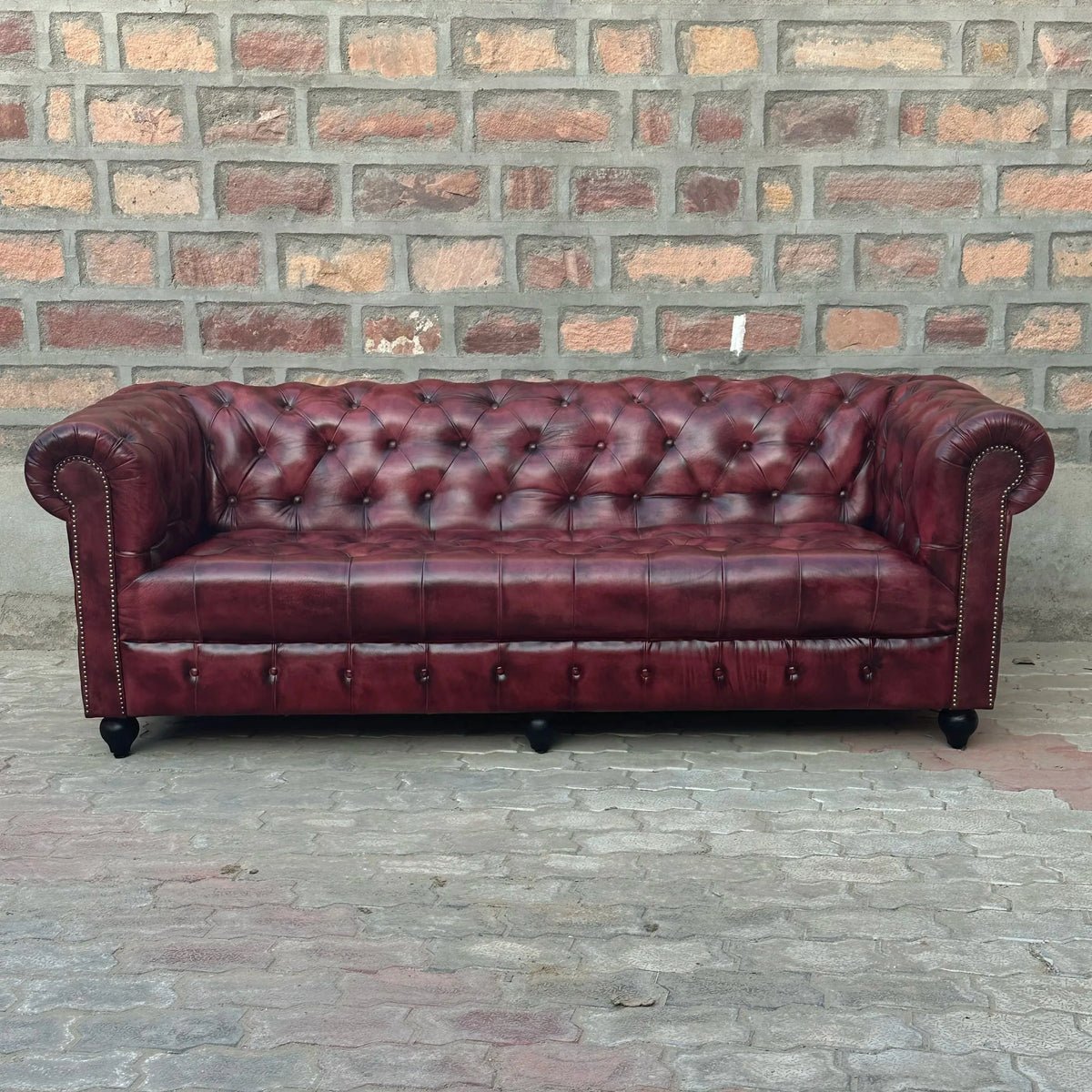 A close-up photograph showing a small fabric imperfection on a used sofa.