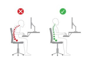 A professional sitting with perfect posture at a clean, modern desk setup.