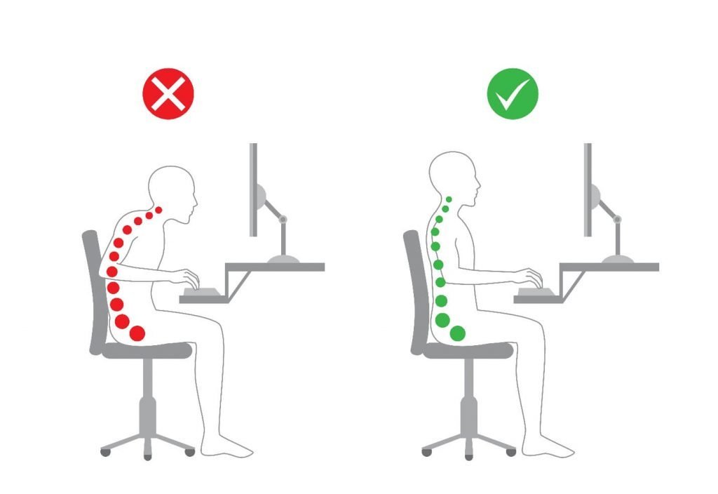 A professional sitting with perfect posture at a clean, modern desk setup.