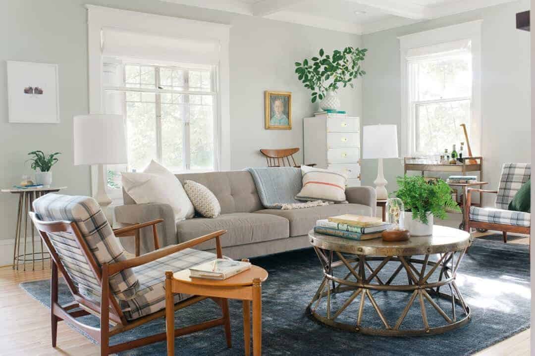 A well-organized living room layout showing a sofa and chairs in conversation.
