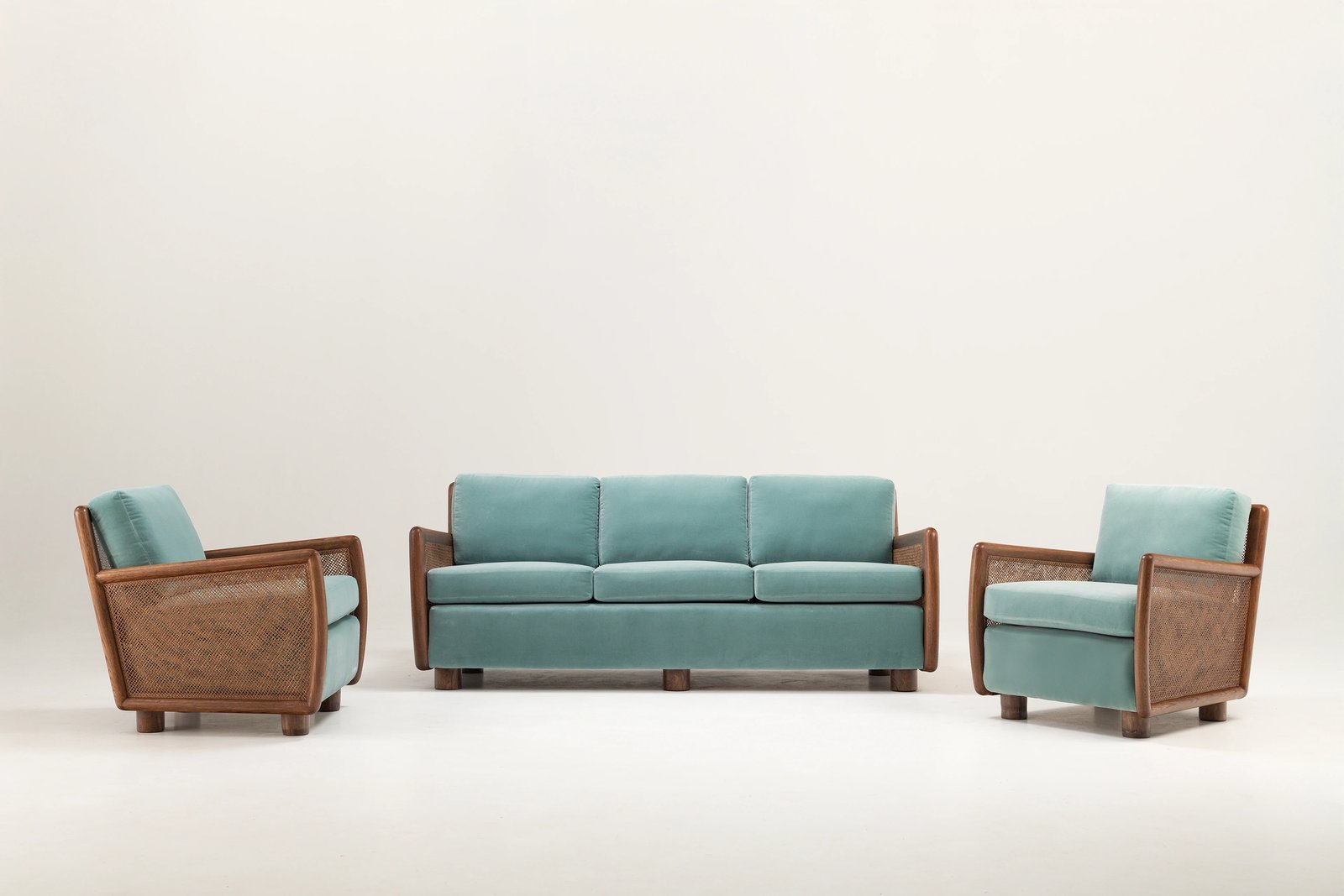An armchair anchored with a lamp showing how to pair sofa and chairs properly.