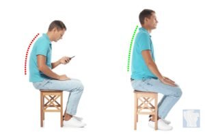 A person practicing ergonomic sitting habits to maintain a straight back at their desk.