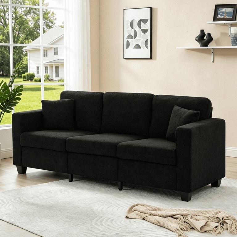 Measuring the total width of a three-seater sofa in a modern living room.