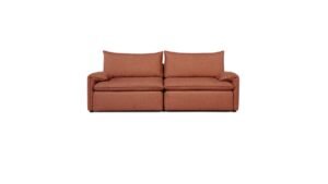 A modern three-seater sofa sits in a bright and spacious living room.