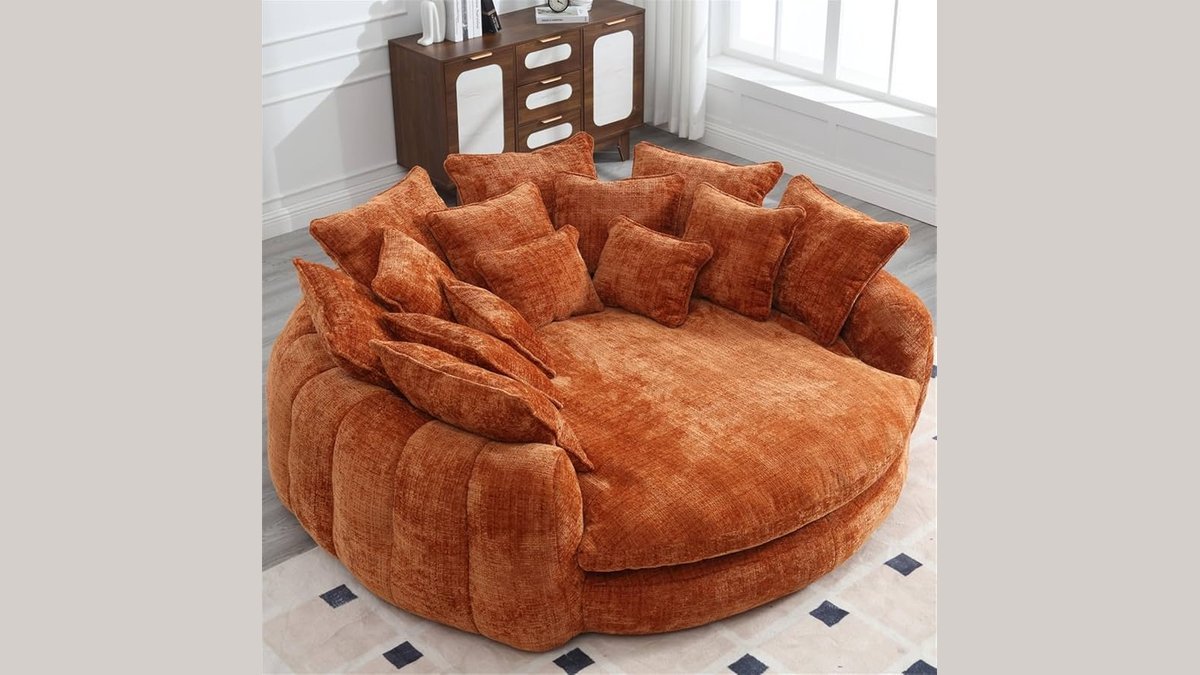 A modern lounge chair displayed in a bright and spacious living room setting.