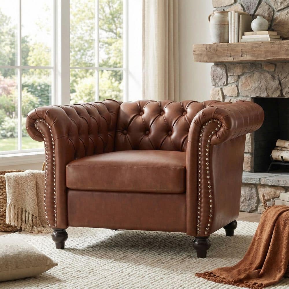 A person using a soft brush attachment to vacuum a couch for proper maintenance.