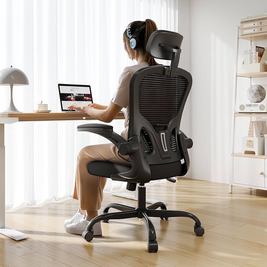 A person sitting with excellent posture in an ergonomic office chair at work.