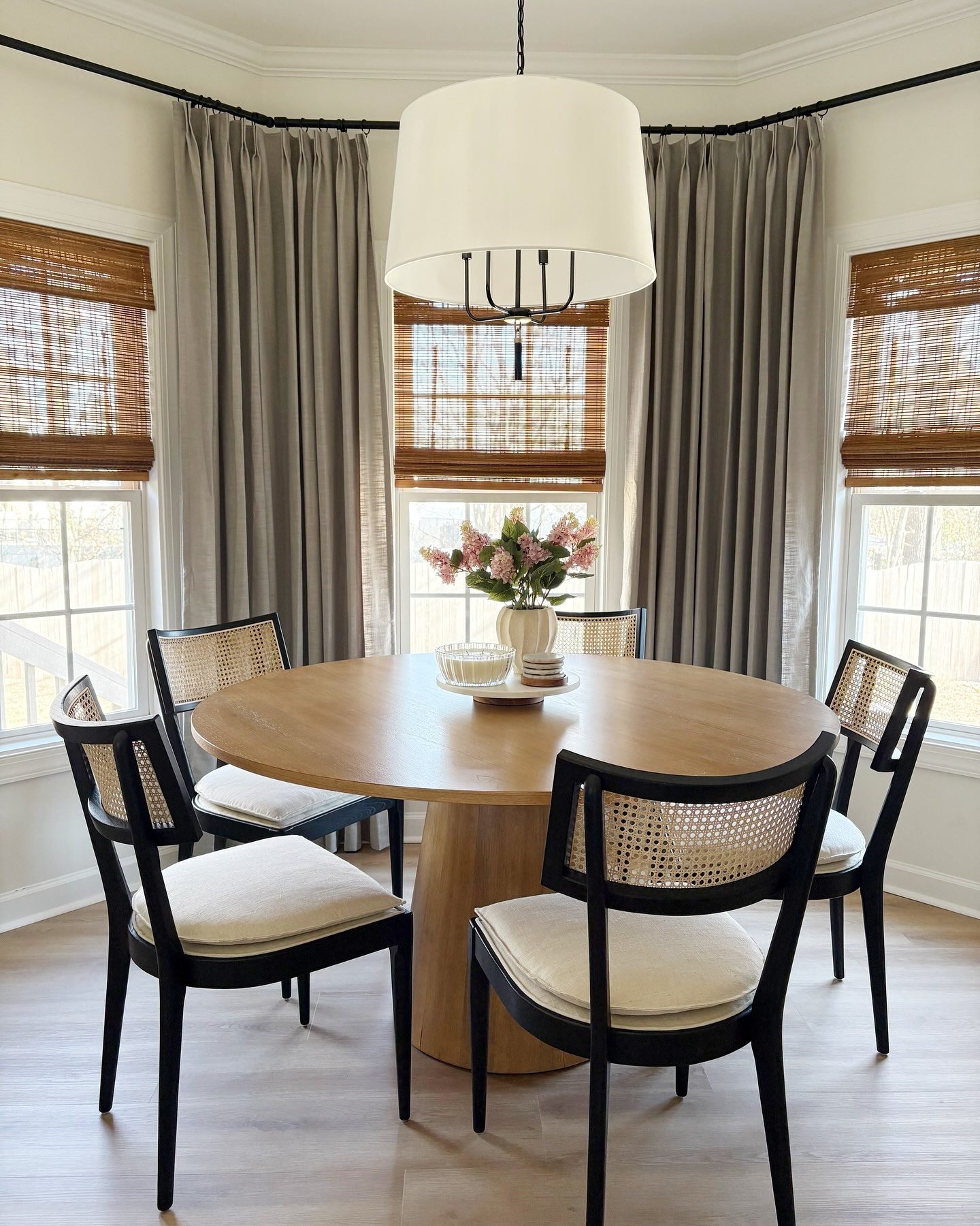 The Libby black wood and natural cane dining chair showcases a blend of dark wood and organic cane.