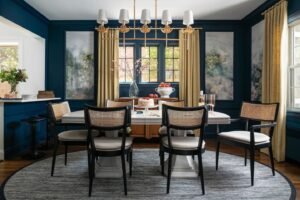 A Libby black wood and natural cane dining chair stands in a bright, modern dining room.