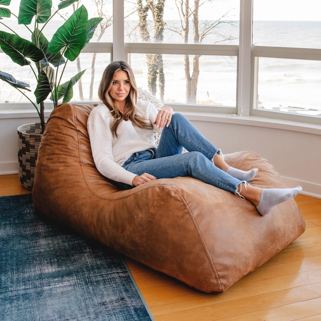 A person extending the hidden ottoman feature on a functional sleeping lounge chair.