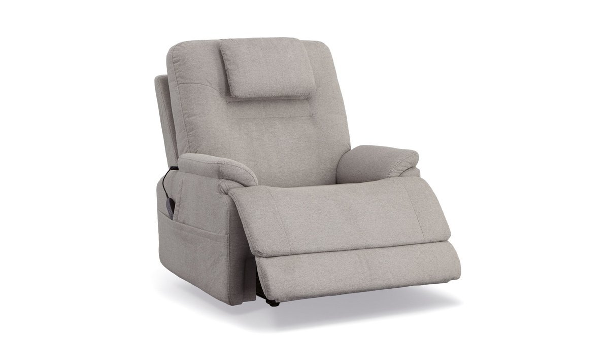A comfortable modern lounge chair for sleeping placed in a sunlit living room.