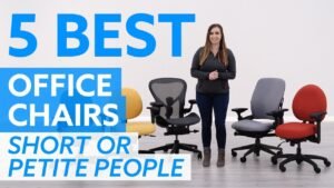 A petite woman working comfortably in an ergonomic office chair designed for smaller frames.